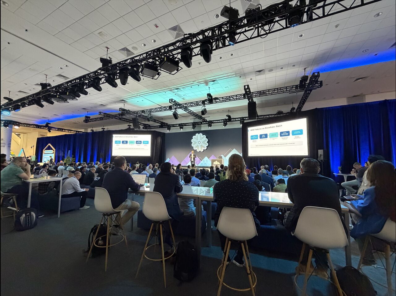 Sam Gupta speaking on the main stage at a Snowflake event